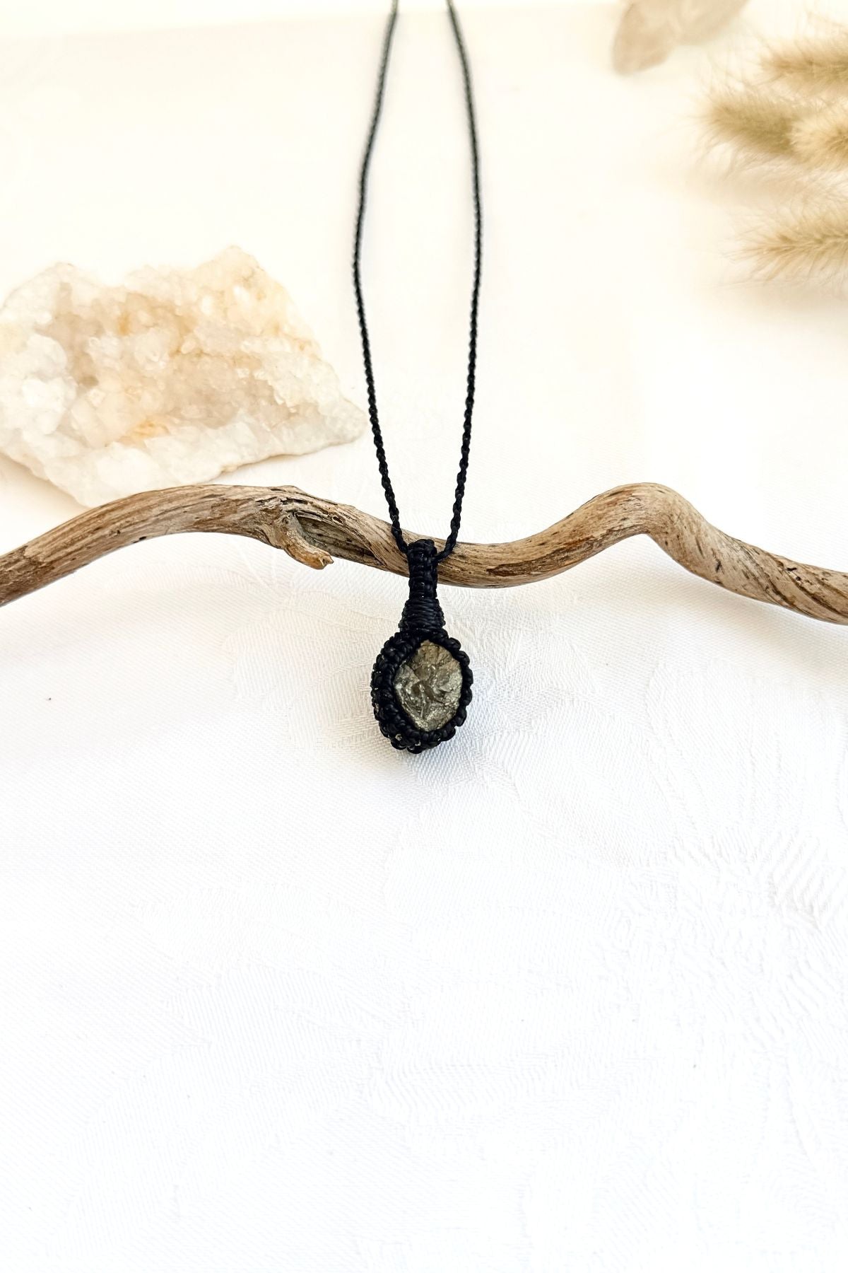 Handmade Pyrite macramé necklace, side view showing the gemstone and macramé knotting