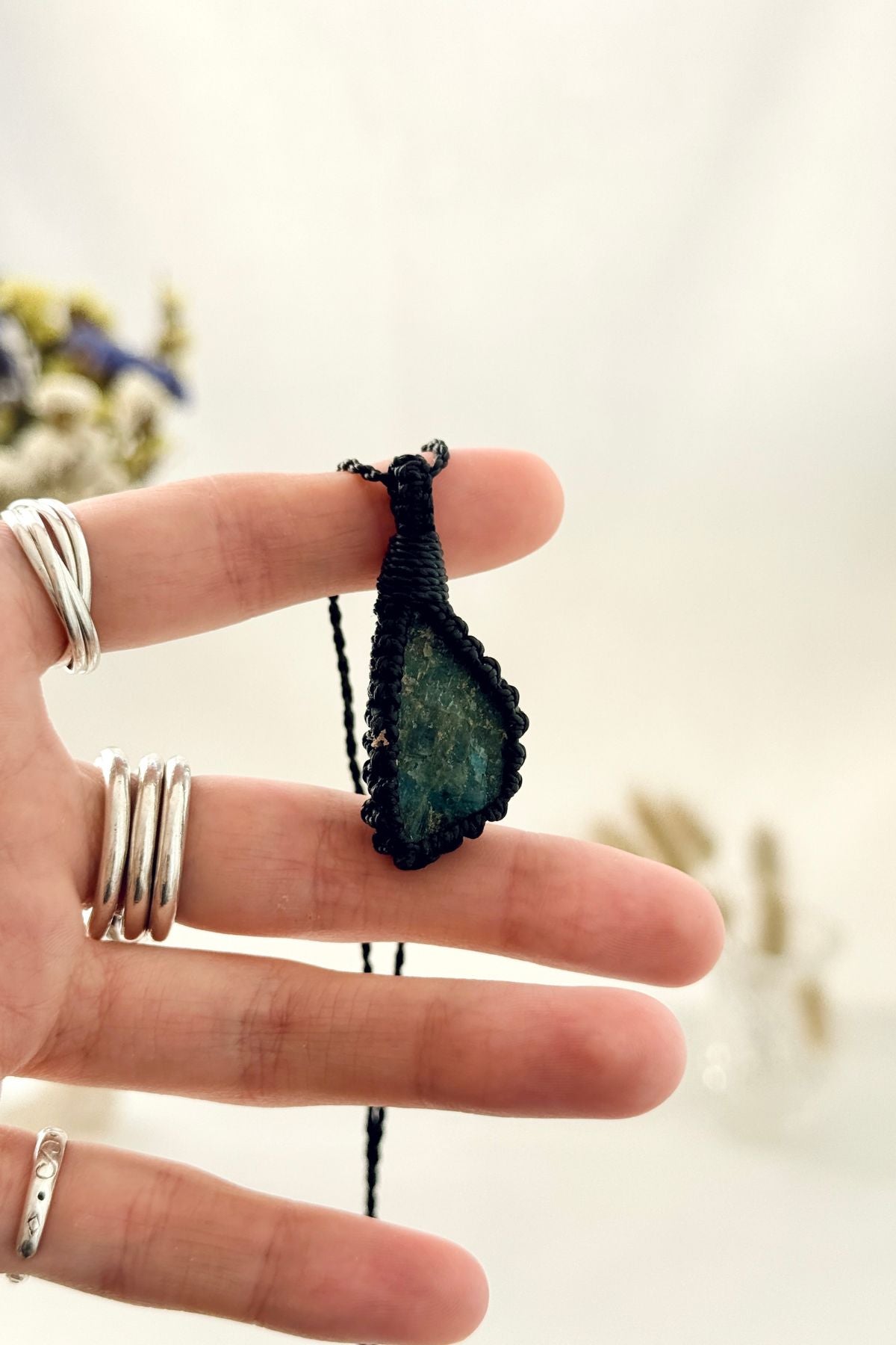 Handmade Apatite macramé necklace held in hand, delicate natural gemstone jewelry
