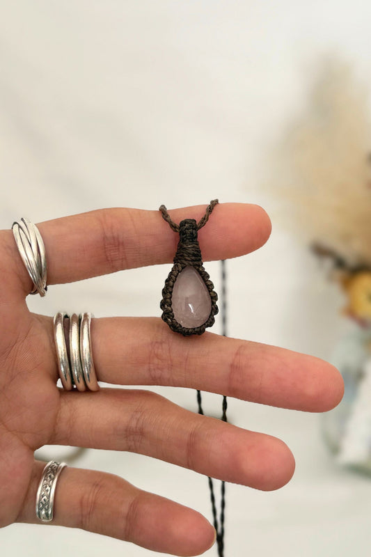 Hand holding a handmade Rose Quartz Macrame necklace from the Essence collection, featuring a high-quality gemstone in a delicate everyday-wear design.