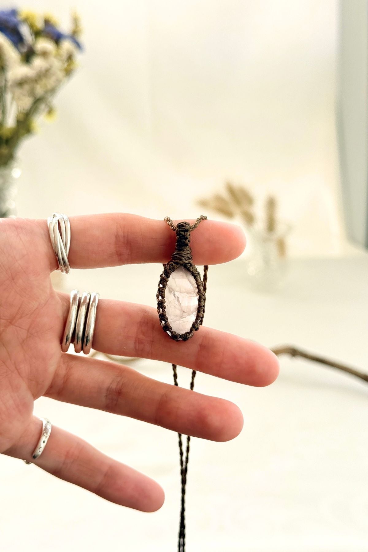Handmade Rose Quartz macramé necklace held in hand, delicate natural gemstone jewelry