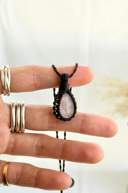 Hand holding a handmade Rose Quartz Macrame necklace from the Essence collection, featuring a high-quality gemstone in a delicate everyday-wear design.