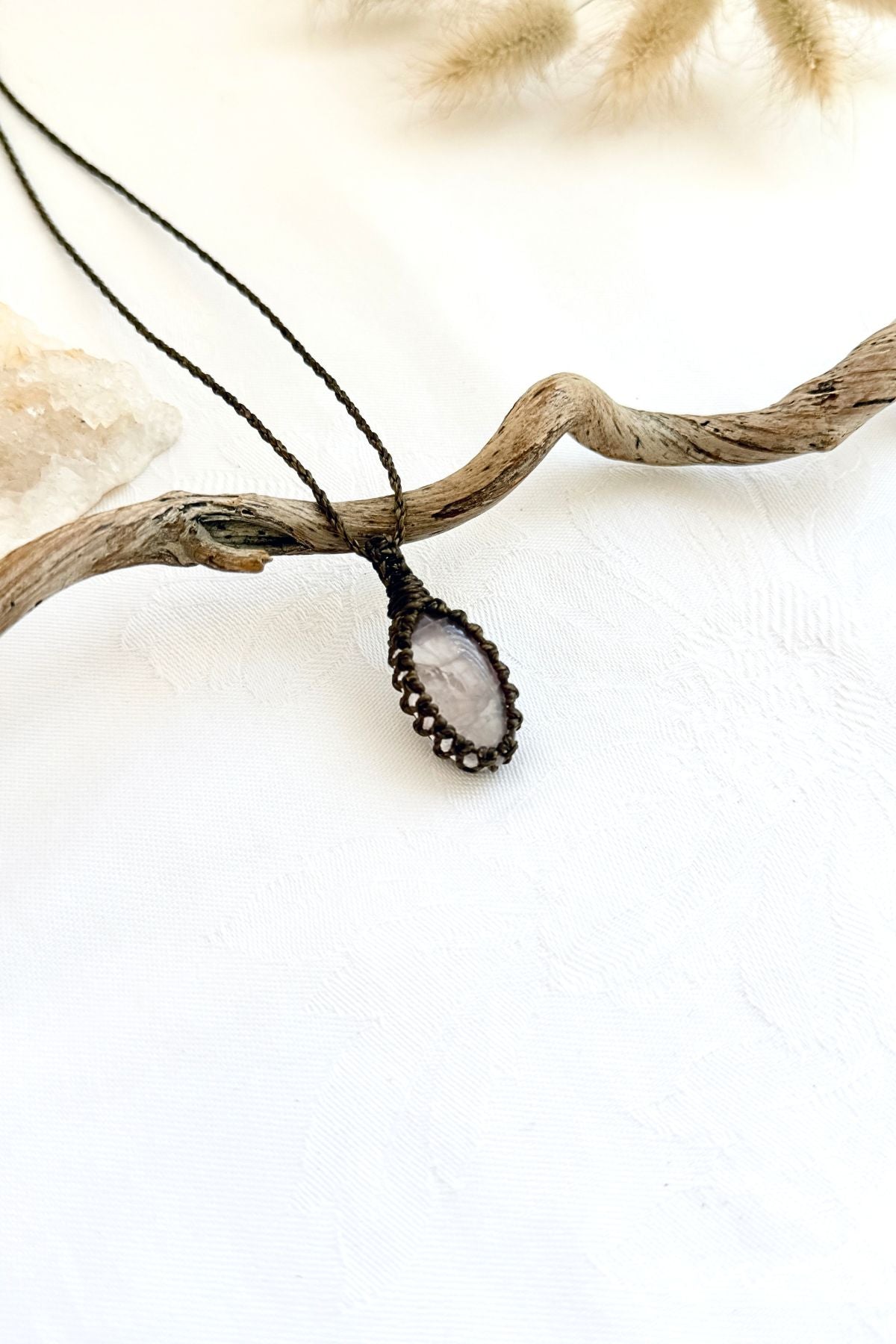Handmade Rose Quartz macramé necklace, side view showing the gemstone and macramé knotting