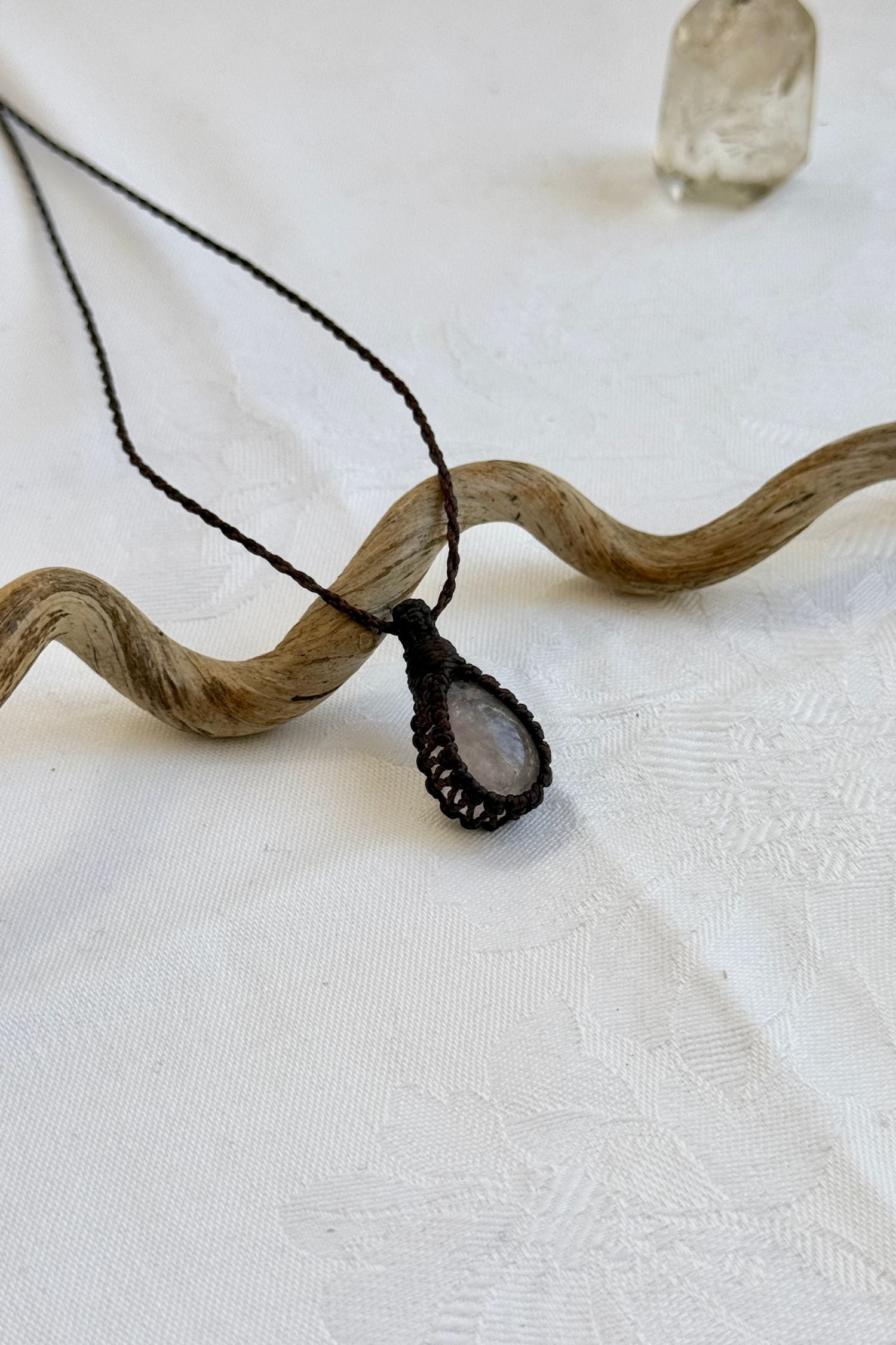 Another side angle shot of the handmade Rose Quartz Macrame necklace, emphasizing the elegant craftsmanship and natural gemstone colors.