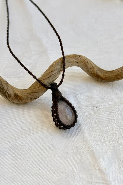 Close-up of handmade Rose Quartz Macrame necklace, showcasing the intricate macrame knotting and the vibrant patterns of the gemstone.