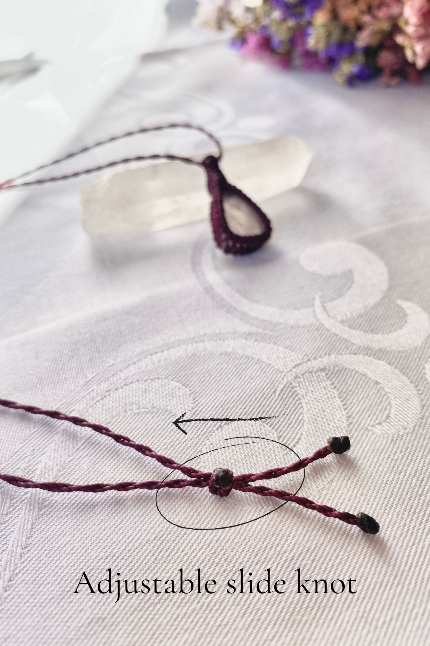 Close-up of the adjustable sliding knot on the rose quartz macrame necklace, allowing for a customizable and comfortable fit.