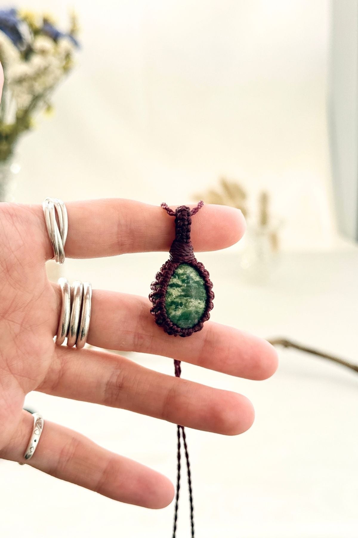 Handmade Ruby Fuchsite macramé necklace held in hand, delicate natural gemstone jewelry