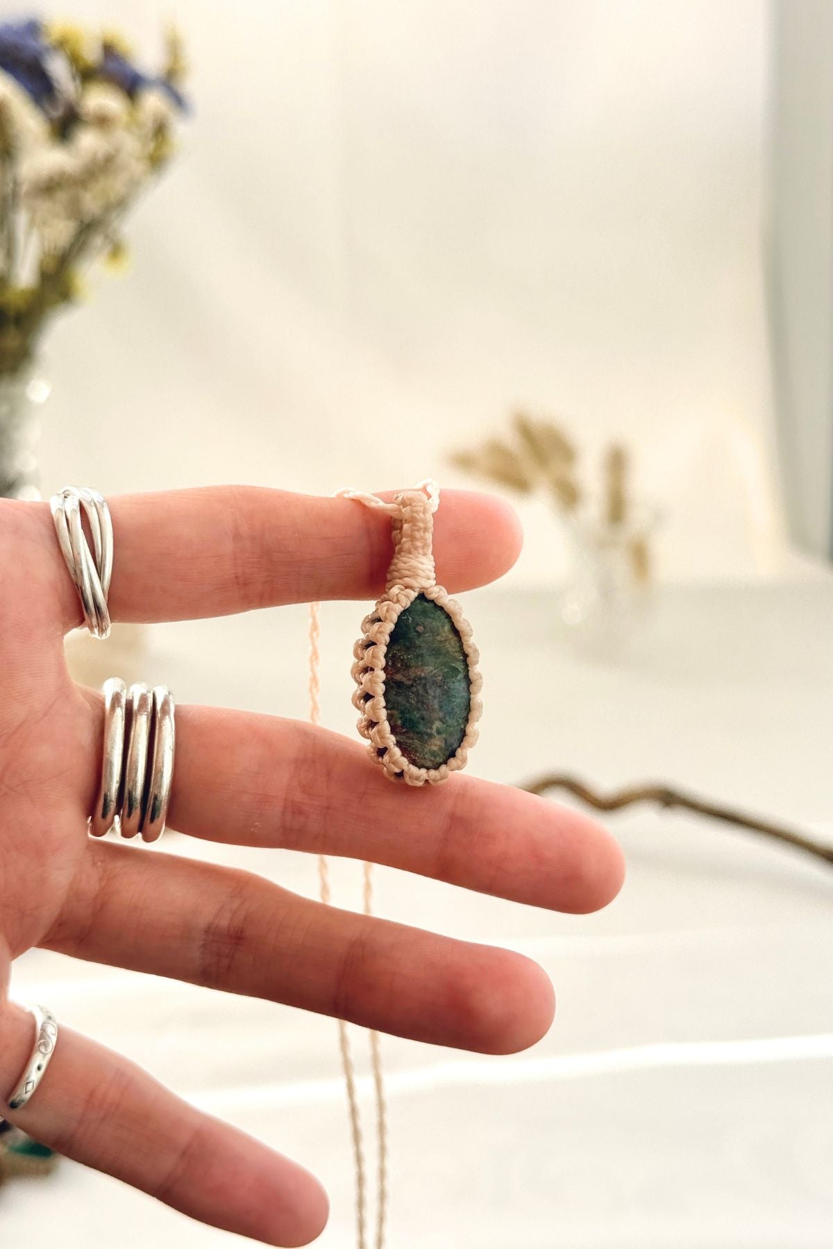 Handmade Ruby Fuchsite macramé necklace held in hand, delicate natural gemstone jewelry
