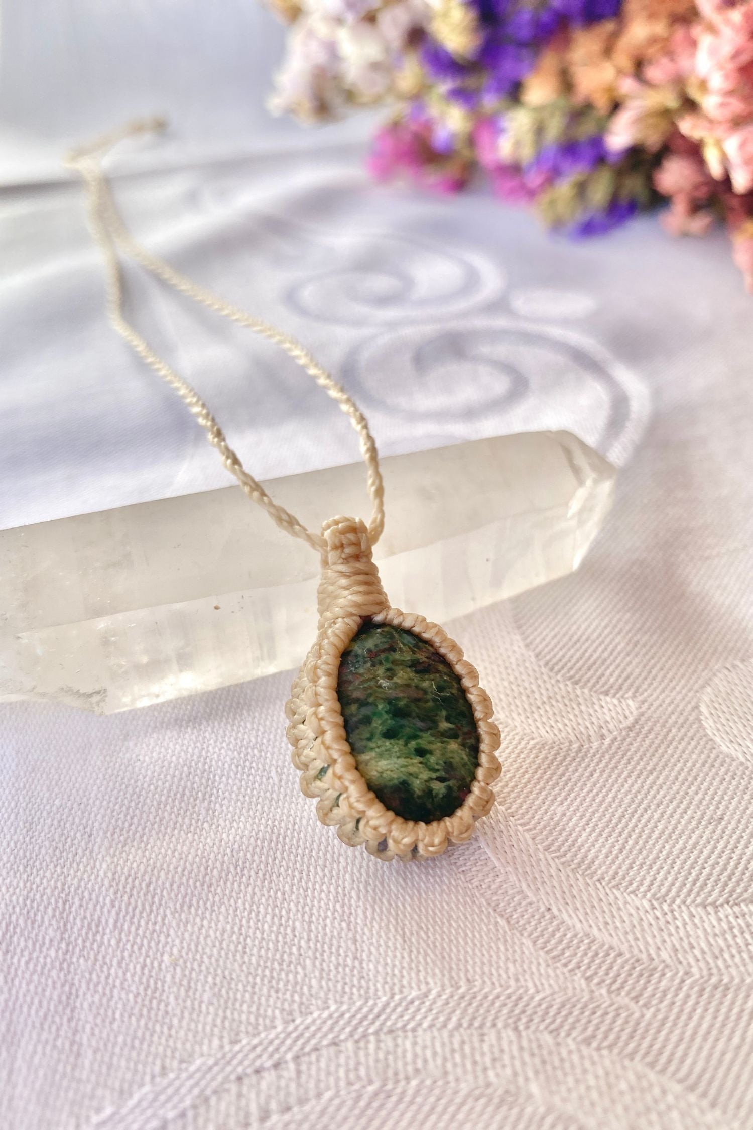 Side angle view of the Ruby Fuchsite Macrame necklace, showing the fine macrame details and the unique natural gemstone centerpiece.