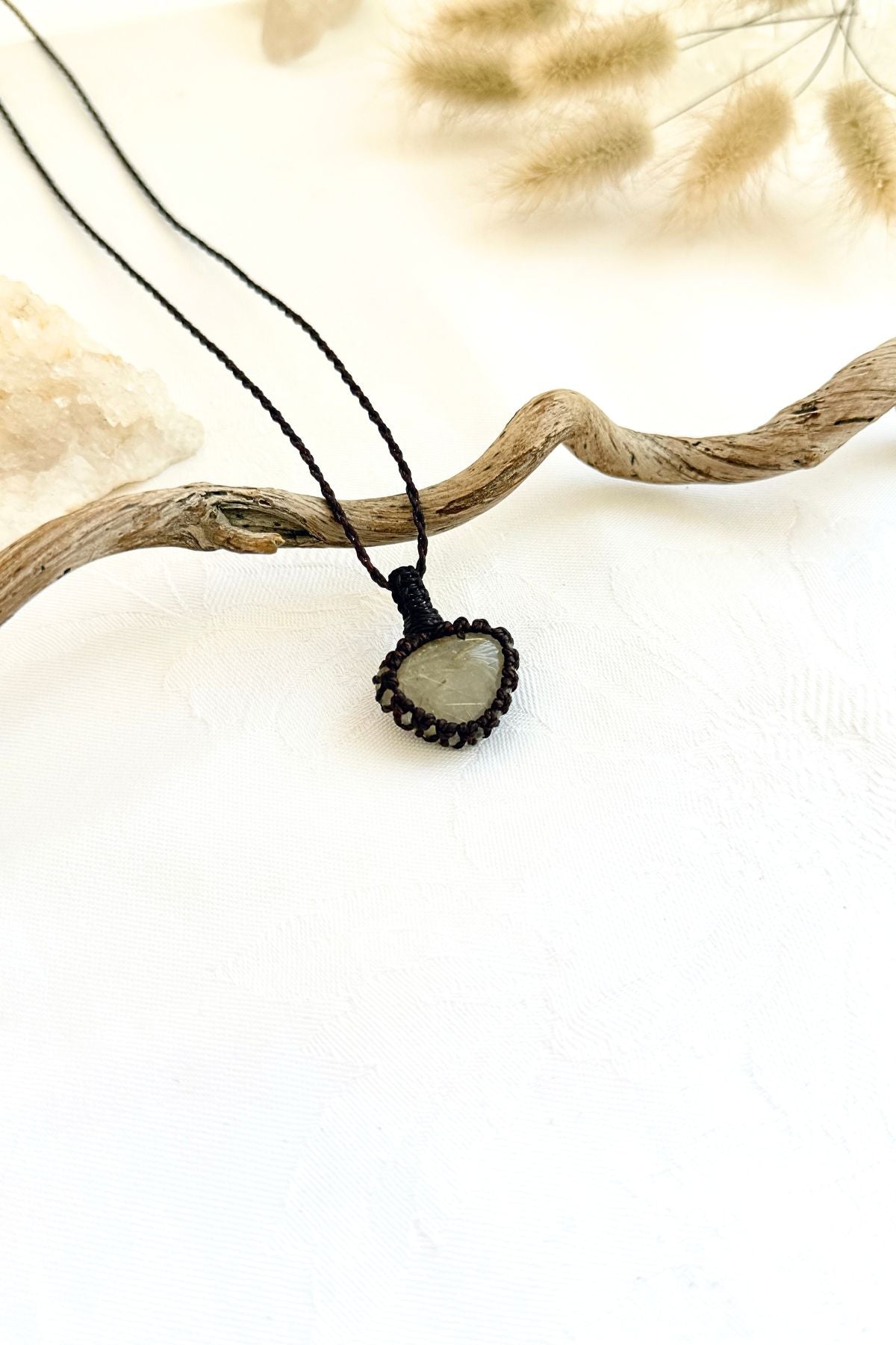 Handmade Rutilated Quartz macramé necklace, side view showing the gemstone and macramé knotting