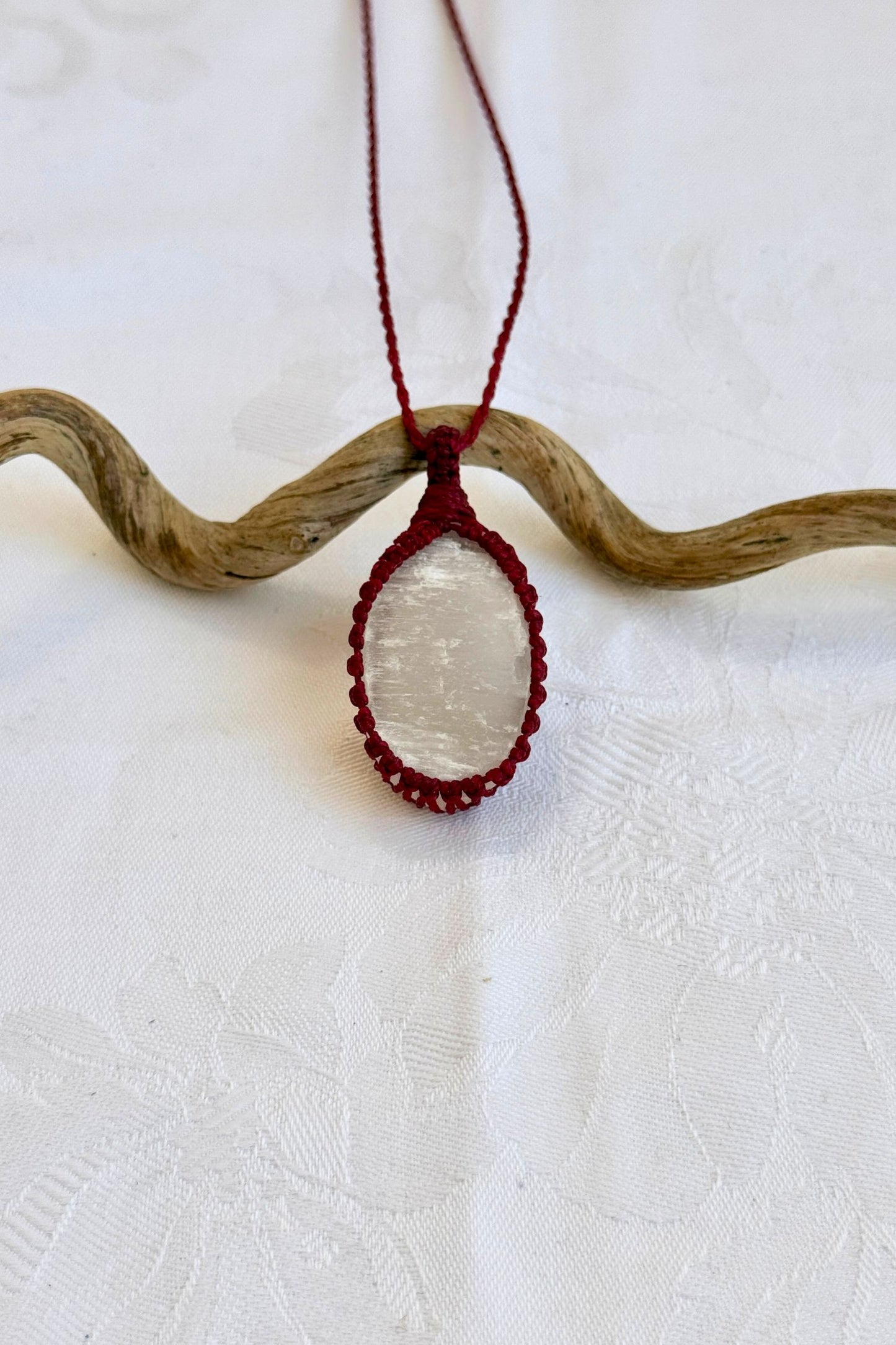 Handmade Selenite Macrame necklace featuring a high-quality gemstone, laid flat to showcase its delicate everyday-wear design from the Essence collection.