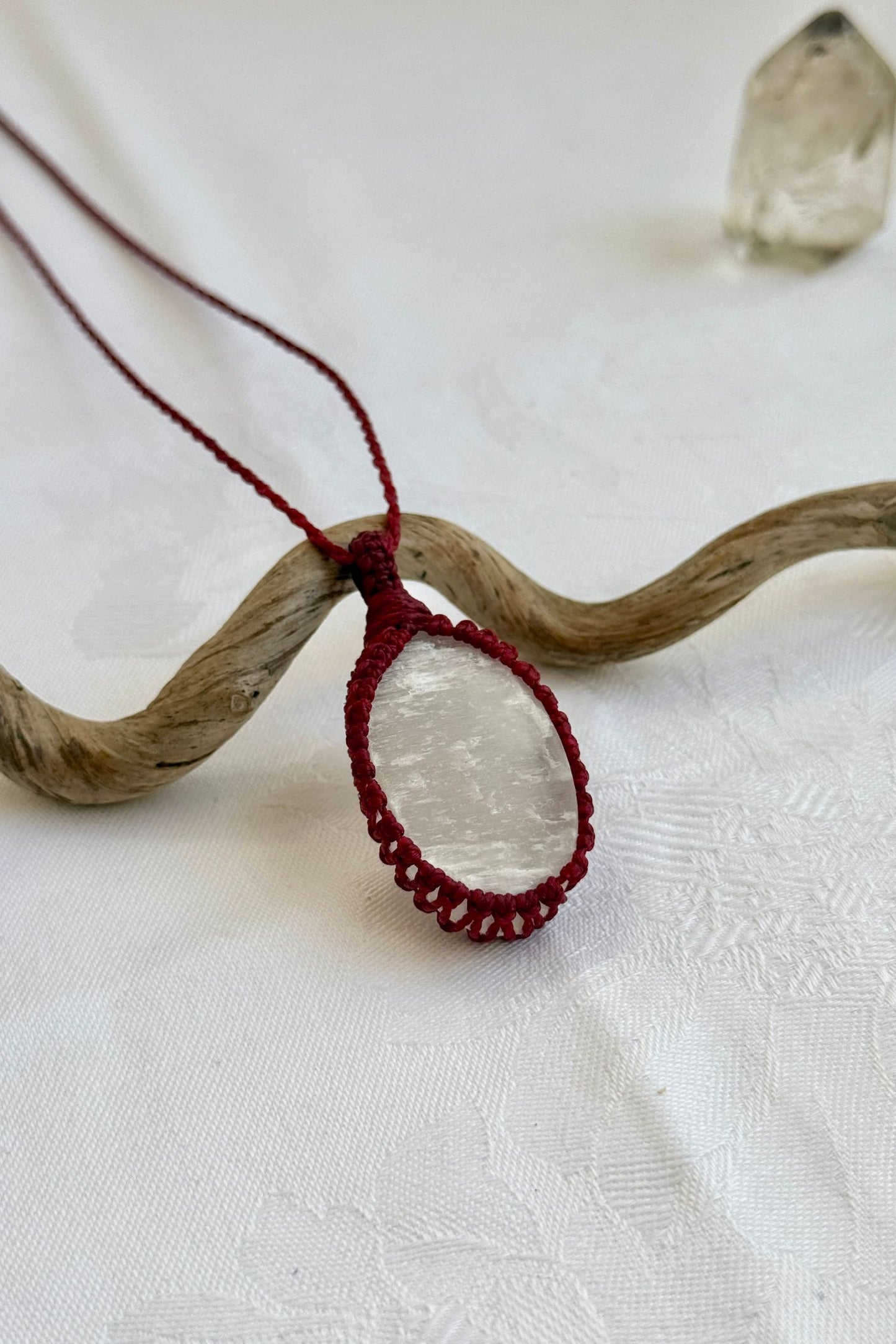 Another side angle shot of the handmade Selenite Macrame necklace, emphasizing the elegant craftsmanship and natural gemstone colors.