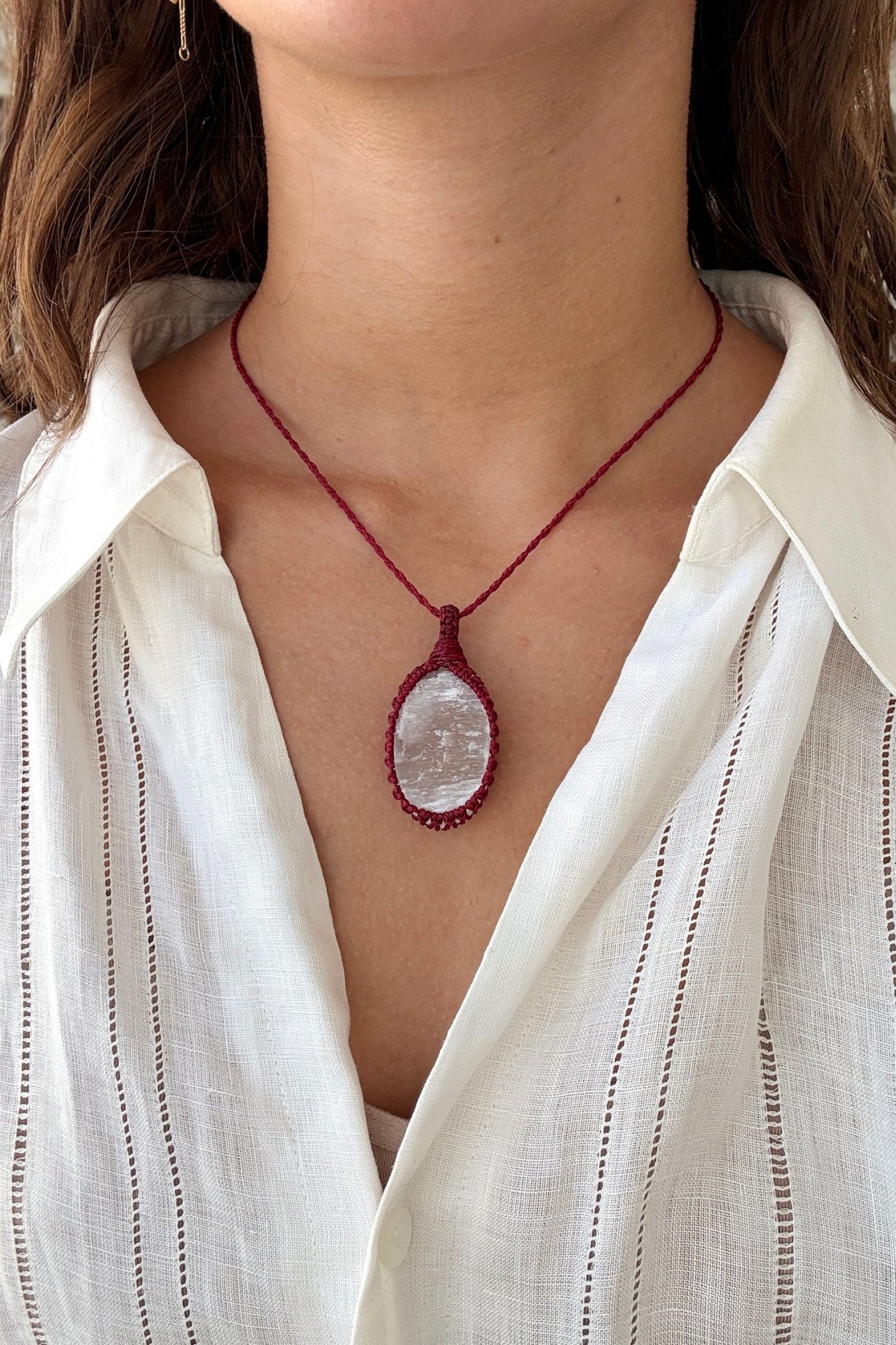 Model wearing a delicate handmade Selenite macrame necklace with a red cord, perfect for everyday wear.