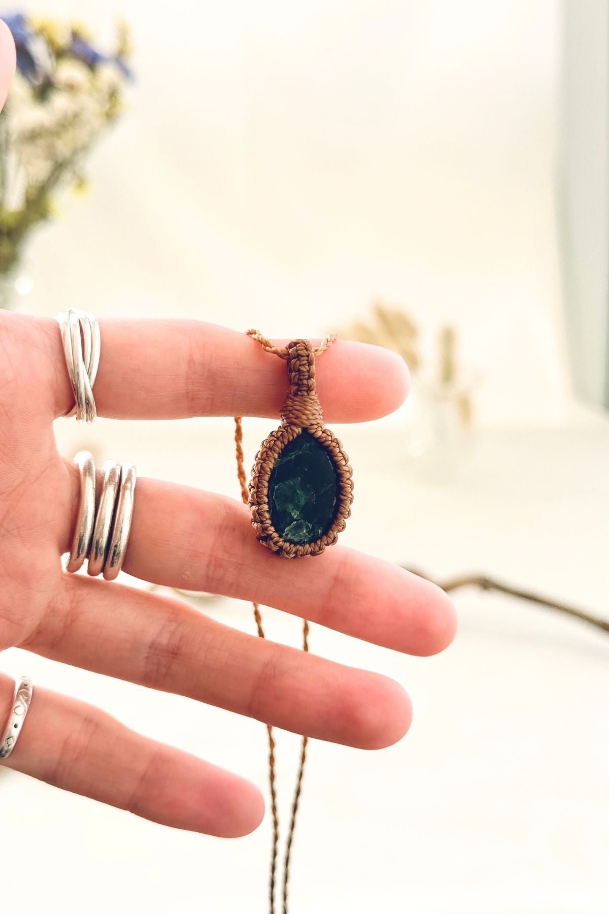 Handmade Seraphinite macramé necklace held in hand, delicate natural gemstone jewelry