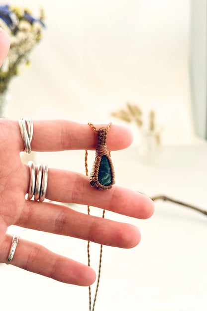Handmade Seraphinite macramé necklace held in hand, delicate natural gemstone jewelry