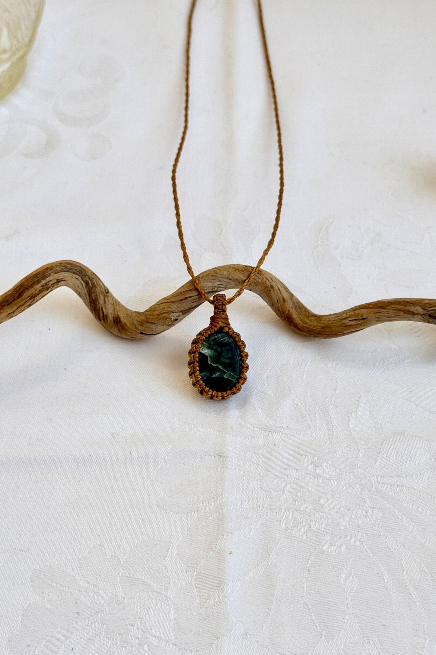 Handmade Seraphinite Macrame necklace featuring a high-quality gemstone, laid flat to showcase its delicate everyday-wear design from the Essence collection.
