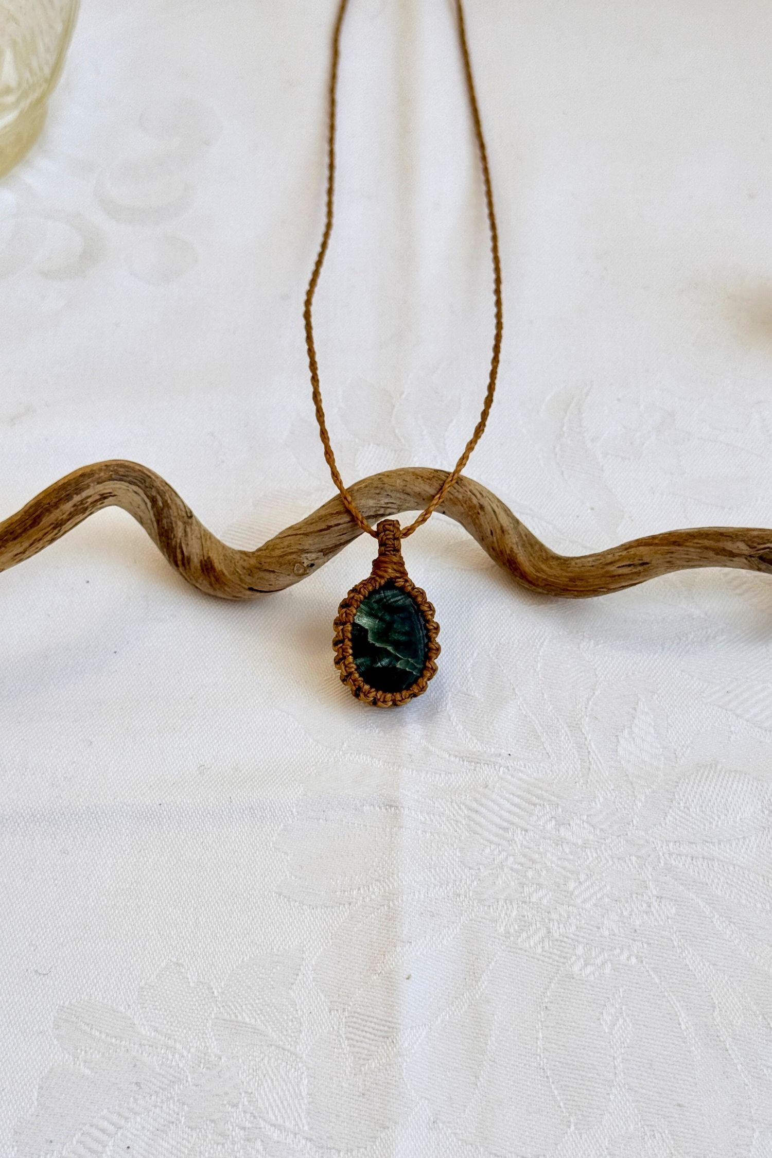 Handmade Seraphinite Macrame necklace featuring a high-quality gemstone, laid flat to showcase its delicate everyday-wear design from the Essence collection.