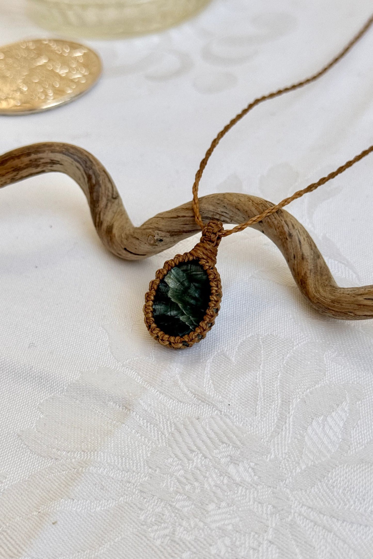 Another side angle shot of the handmade Seraphinite Macrame necklace, emphasizing the elegant craftsmanship and natural gemstone colors.
