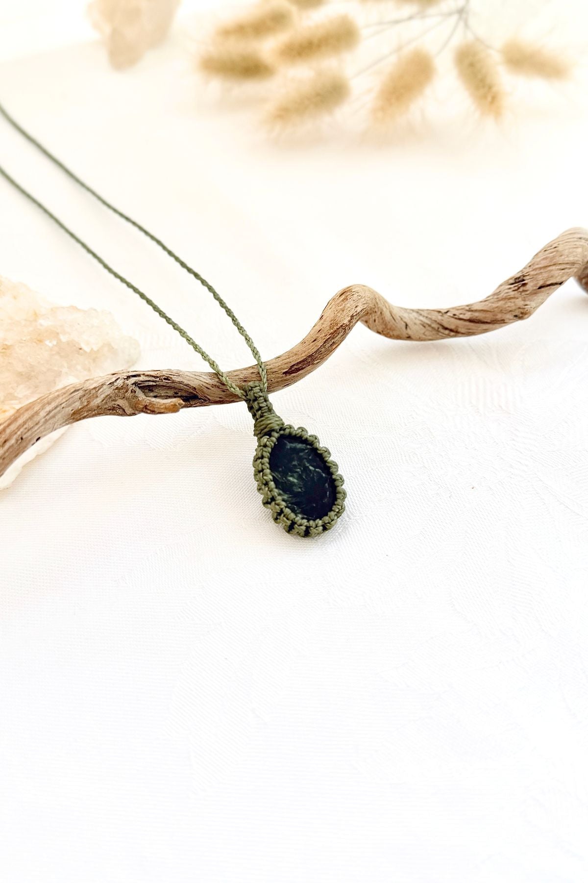 Handmade Seraphinite macramé necklace, side view showing the gemstone and macramé knotting