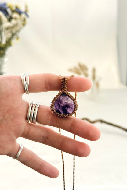 Handmade Star Amethyst macramé necklace held in hand, delicate natural gemstone jewelry