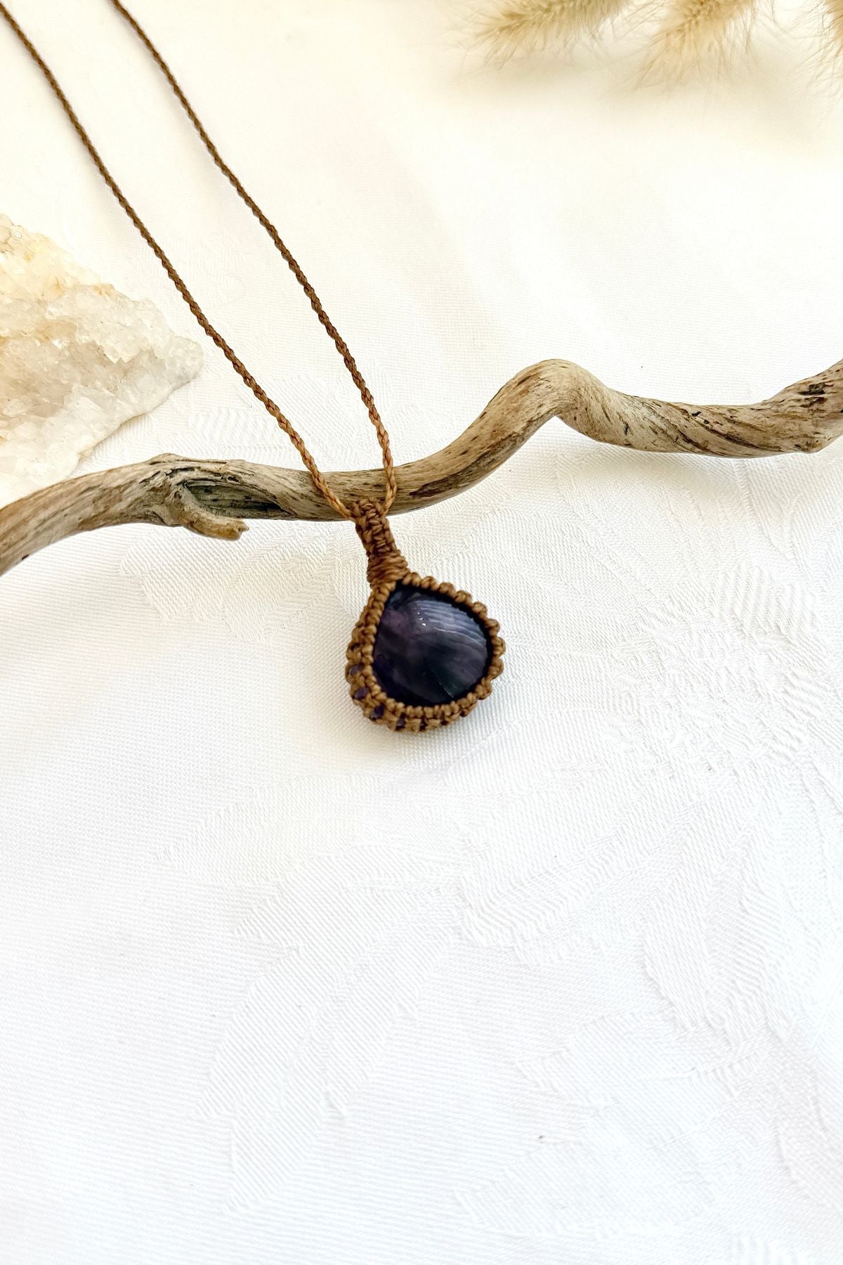 Handmade Star Amethyst macramé necklace, side view showing the gemstone and macramé knotting
