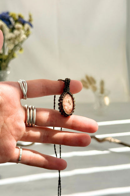 Handmade Sunstone macramé necklace held in hand, delicate natural gemstone jewelry