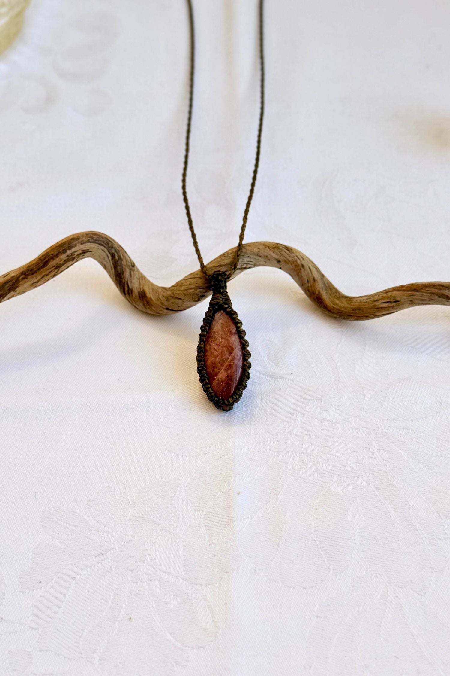 Handmade Sunstone Macrame necklace featuring a high-quality gemstone, laid flat to showcase its delicate everyday-wear design from the Essence collection.