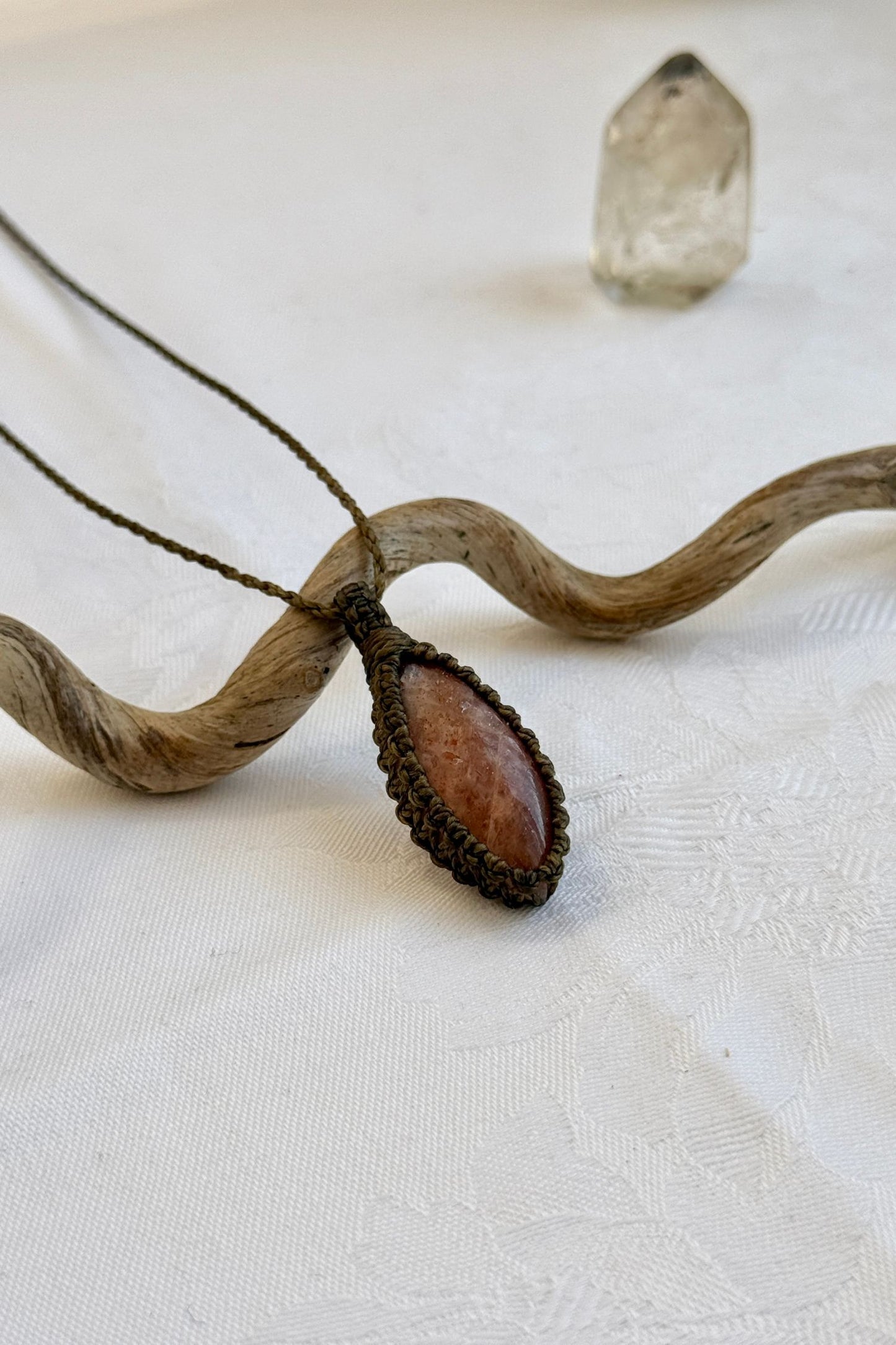 Another side angle shot of the handmade Sunstone Macrame necklace, emphasizing the elegant craftsmanship and natural gemstone colors.