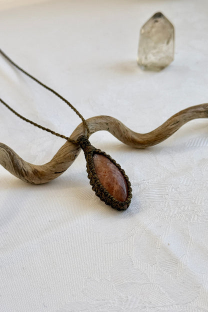 Another side angle shot of the handmade Sunstone Macrame necklace, emphasizing the elegant craftsmanship and natural gemstone colors.