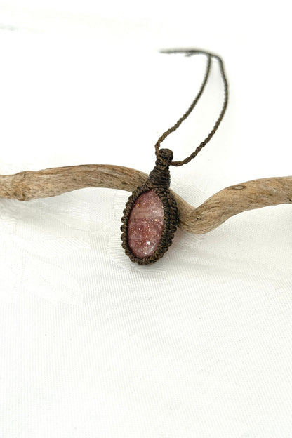Alternate side view of a handmade Sunstone macrame necklace, focusing on the gemstone’s natural glow.