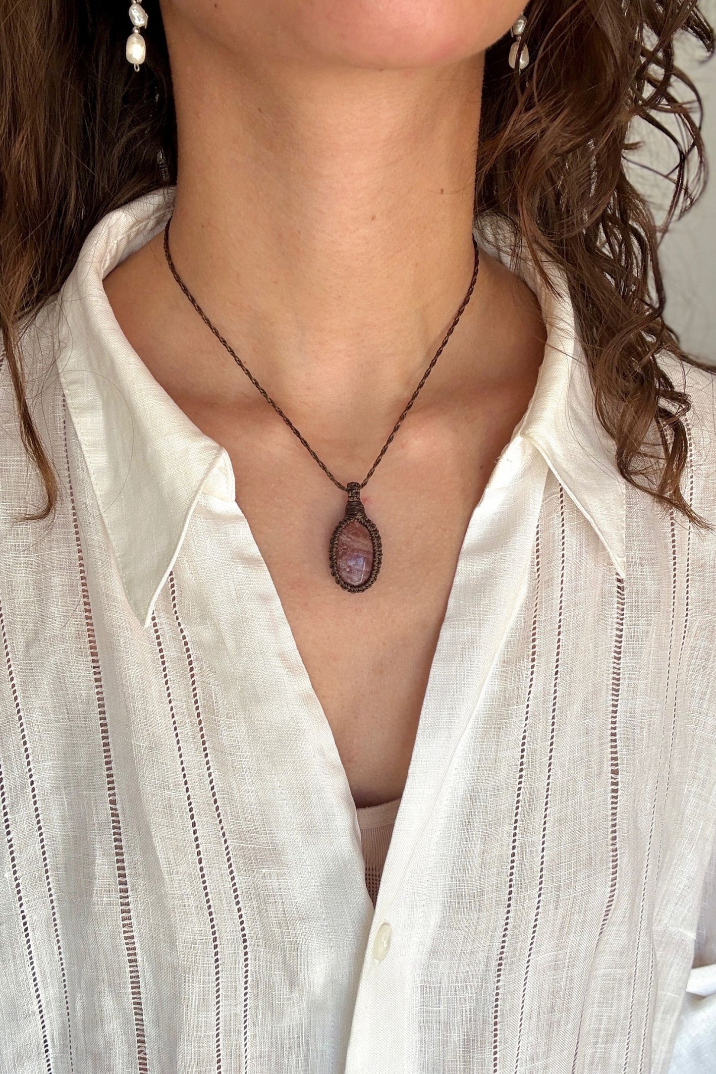 Model wearing a delicate handmade Sunstone macrame necklace with a dark green cord, perfect for everyday wear.