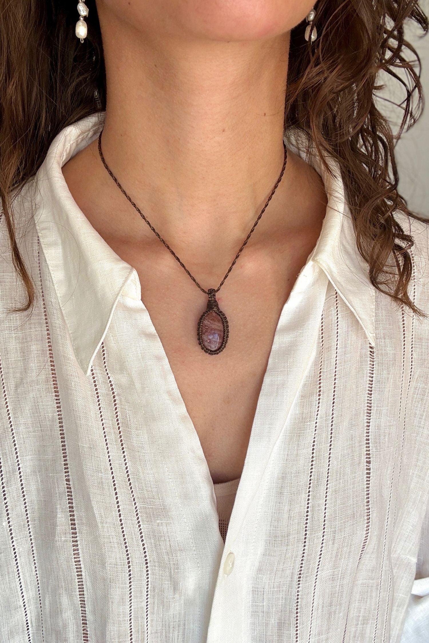 Model wearing a delicate handmade Sunstone macrame necklace with a dark green cord, perfect for everyday wear.
