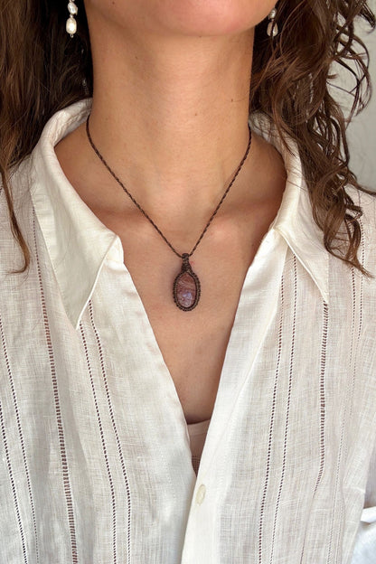 Model wearing a delicate handmade Sunstone macrame necklace with a dark green cord, perfect for everyday wear.