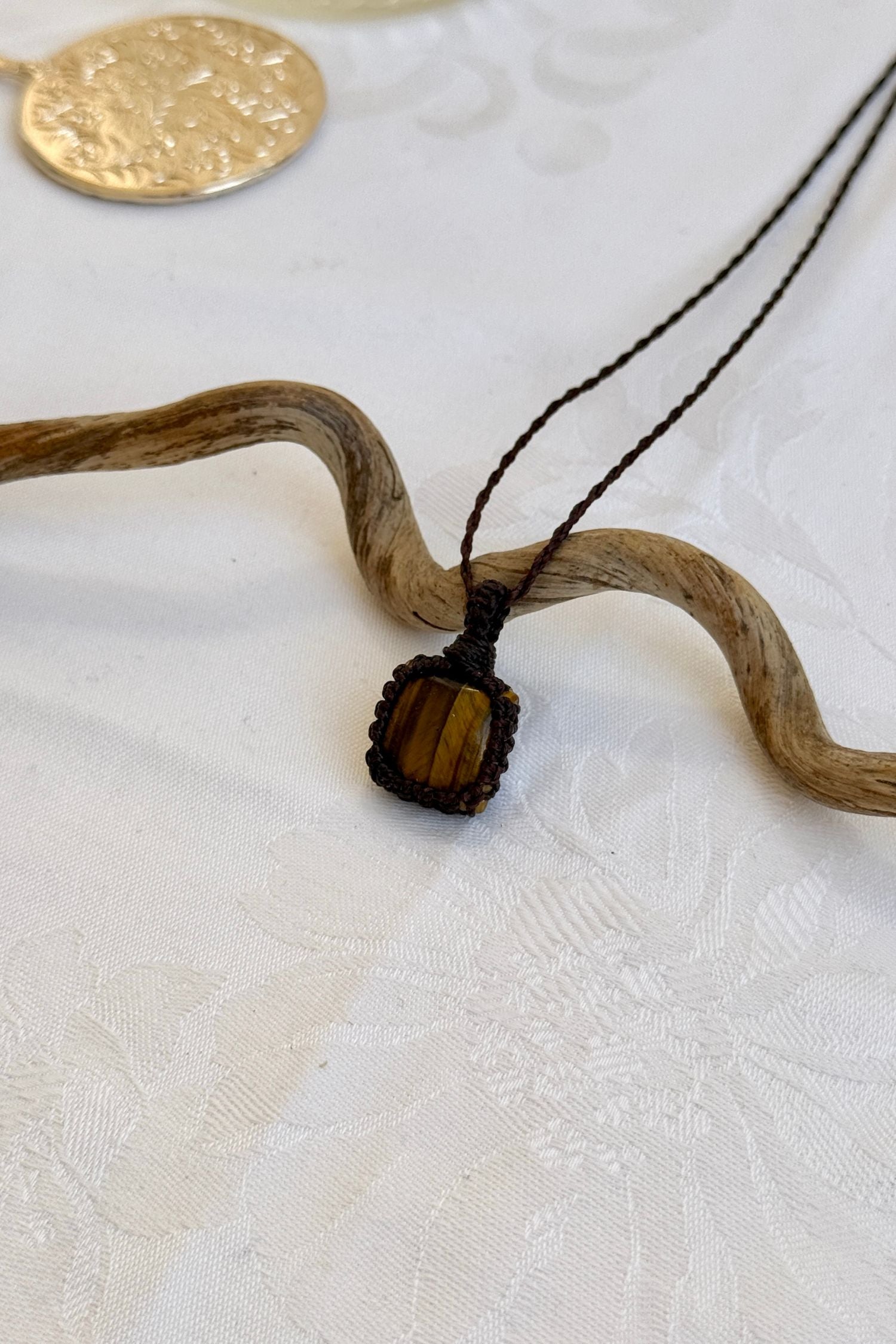 Another side angle shot of the handmade Tiger’s Eye Macrame necklace, emphasizing the elegant craftsmanship and natural gemstone colors.