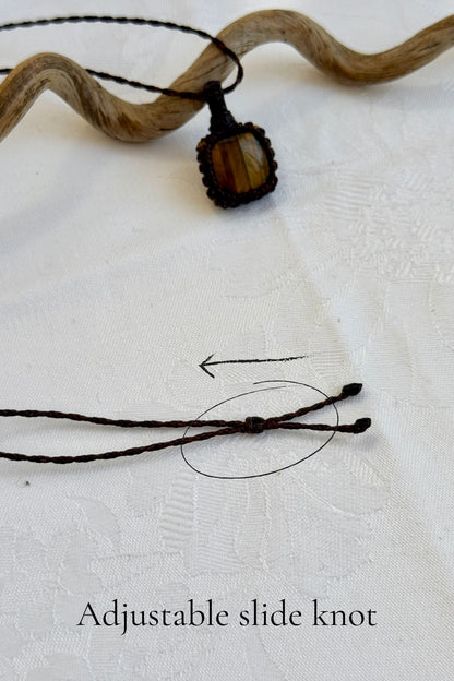 Close-up of the adjustable sliding knot on the Tiger’s Eye Macrame necklace, allowing for an easy and customizable fit for any wearer.