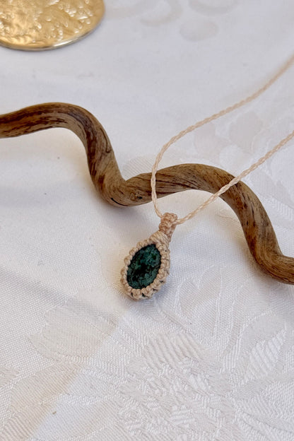 Side angle view of the Turquoise Macrame necklace, showing the fine macrame details and the unique gemstone centerpiece.