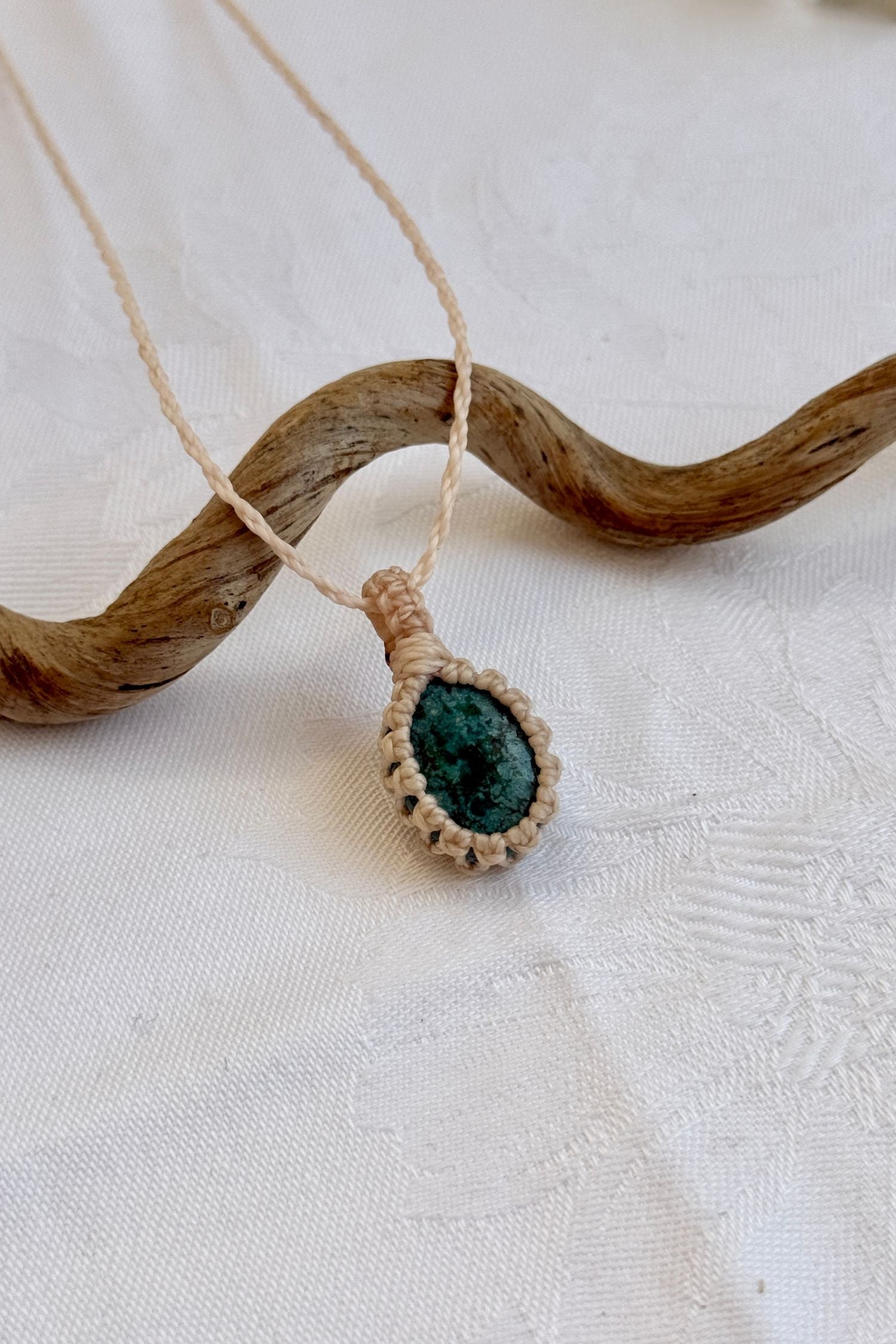 Close-up of handmade Turquoise Macrame necklace, showcasing the intricate macrame knotting and the vibrant patterns of the gemstone.
