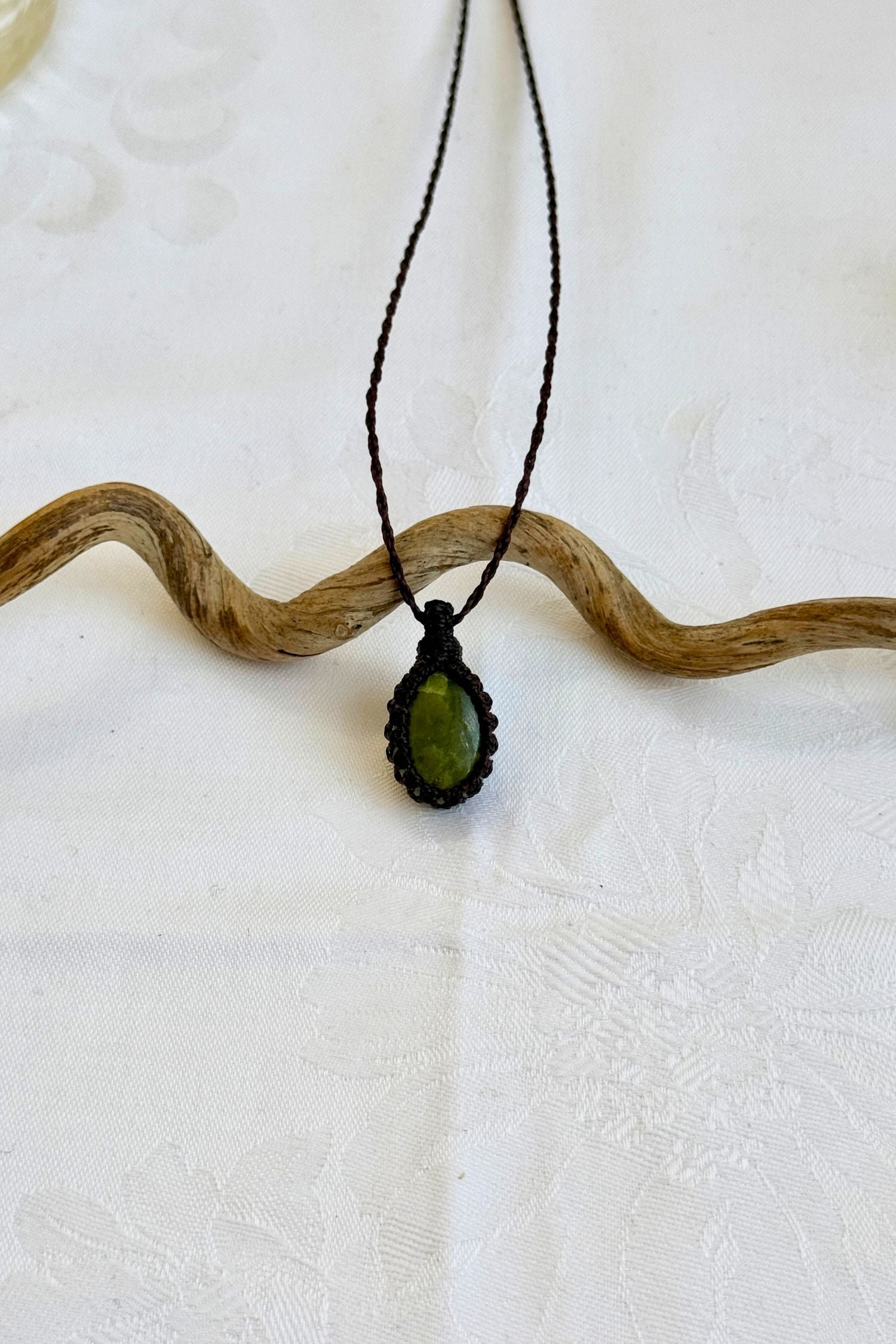 Handmade Vesuvianite Macrame necklace featuring a high-quality gemstone, laid flat to showcase its delicate everyday-wear design from the Essence collection.