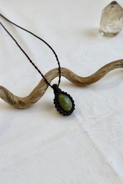 Another side angle shot of the handmade Vesuvianite Macrame necklace, emphasizing the elegant craftsmanship and natural gemstone colors.