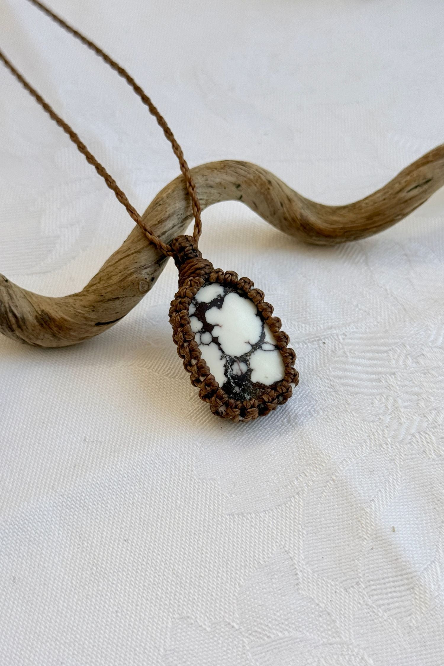 Close-up of handmade Wild Horse Magnesite Macrame necklace, showcasing the intricate macrame knotting and the vibrant patterns of the gemstone.