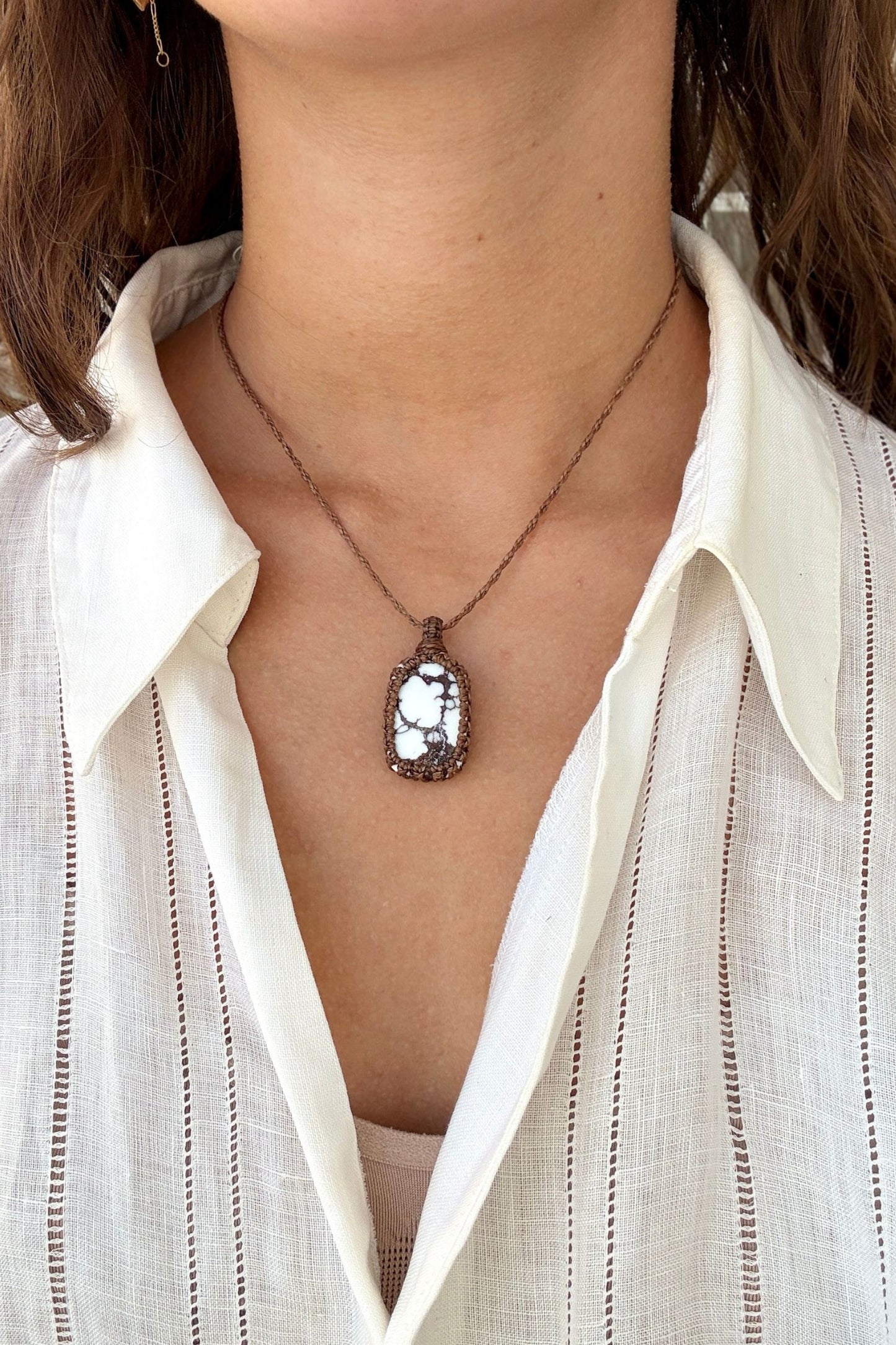 Model wearing a delicate handmade Wild Horse Magnesite macrame necklace with a brown cord, perfect for everyday wear.