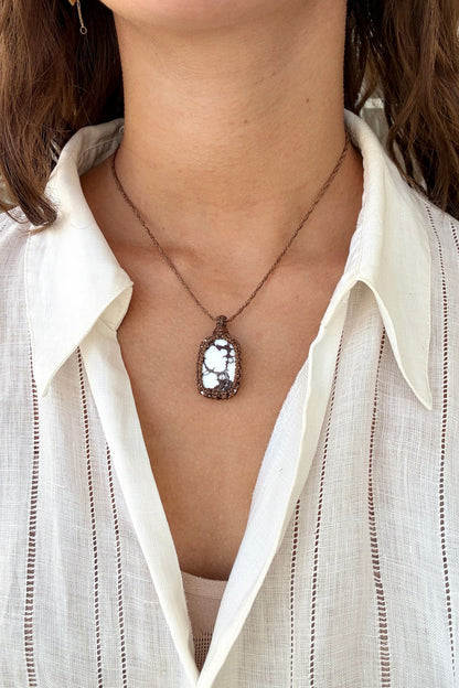 Model wearing a delicate handmade Wild Horse Magnesite macrame necklace with a brown cord, perfect for everyday wear.