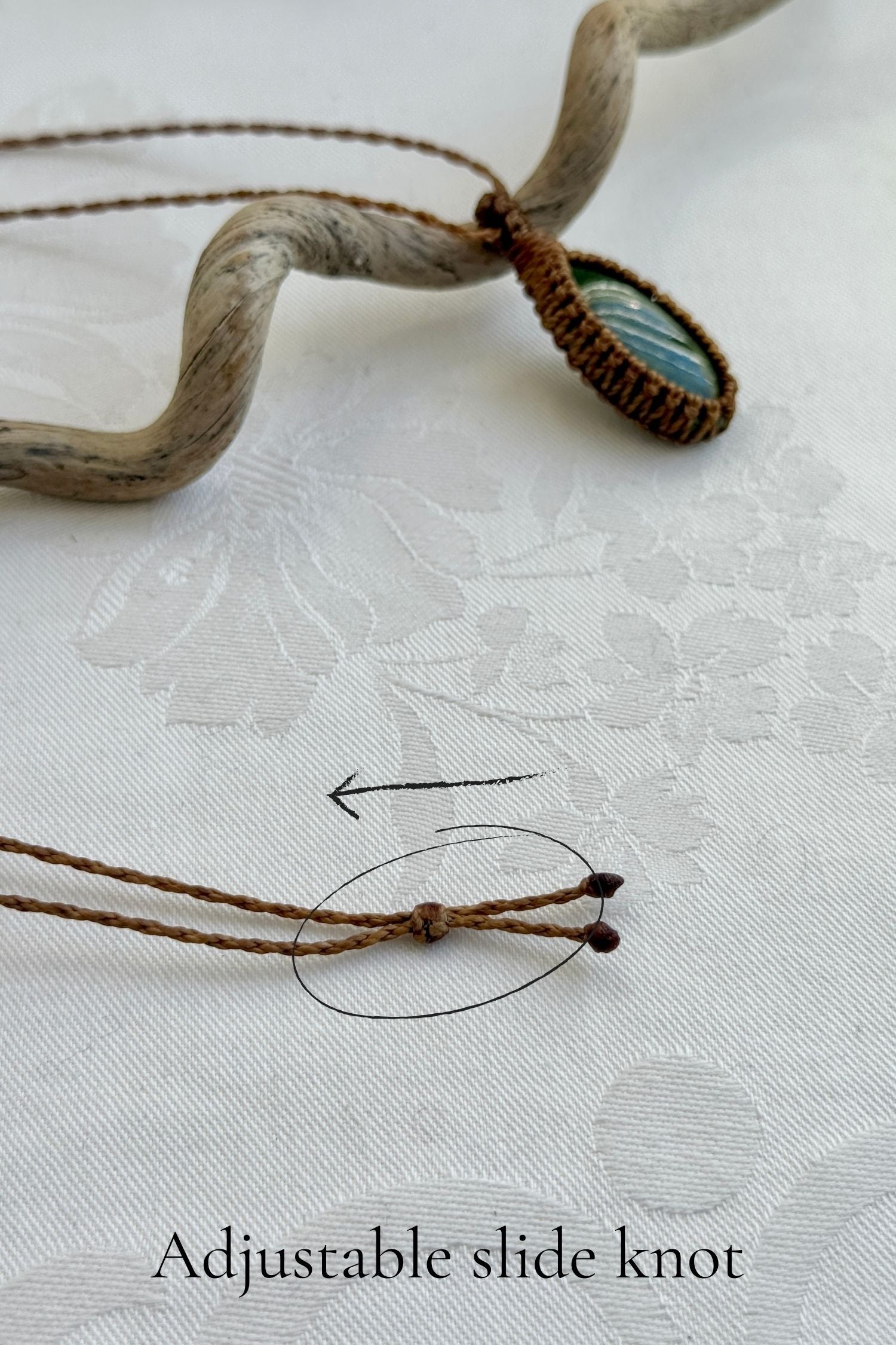 Close-up of the adjustable sliding lock on a handmade Vesuvianite macrame necklace, ensuring a perfect fit for all sizes.