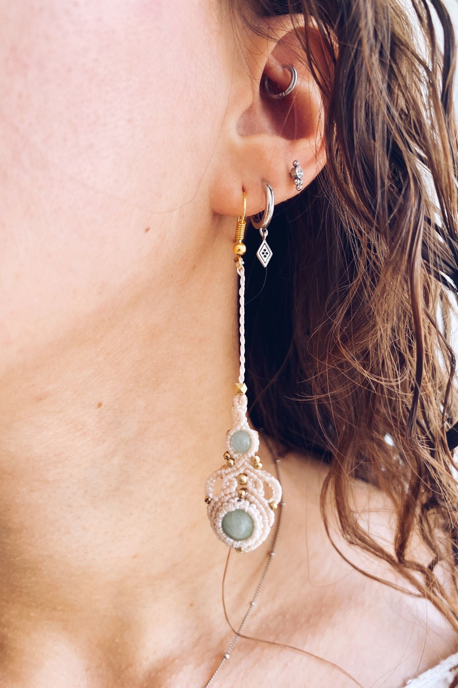 Model wearing handmade macrame earrings featuring amazonite and aquamarine gemstones, showcasing the lightweight, long drop style perfect for any occasion.