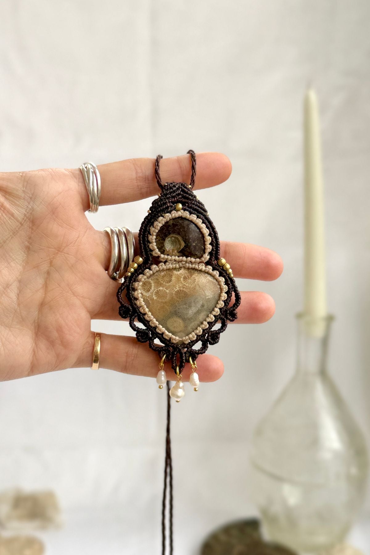 Rare ammonite and fossil coral statement necklace shown in hand, unique ocean fossil jewelry