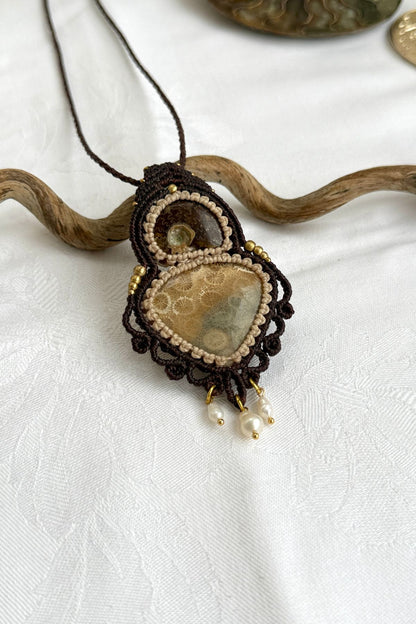 Close-up of rare ammonite and fossil coral pendant with freshwater pearls, natural history jewelry