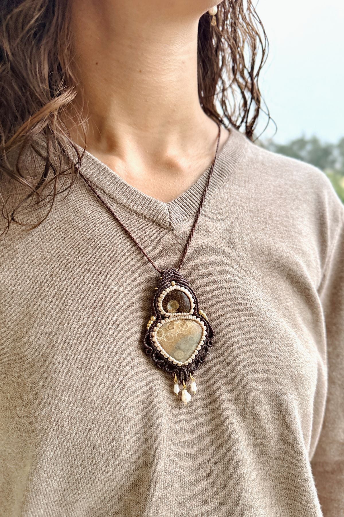 Model wearing rare ammonite and fossil coral statement necklace, luxury ocean inspired jewelry