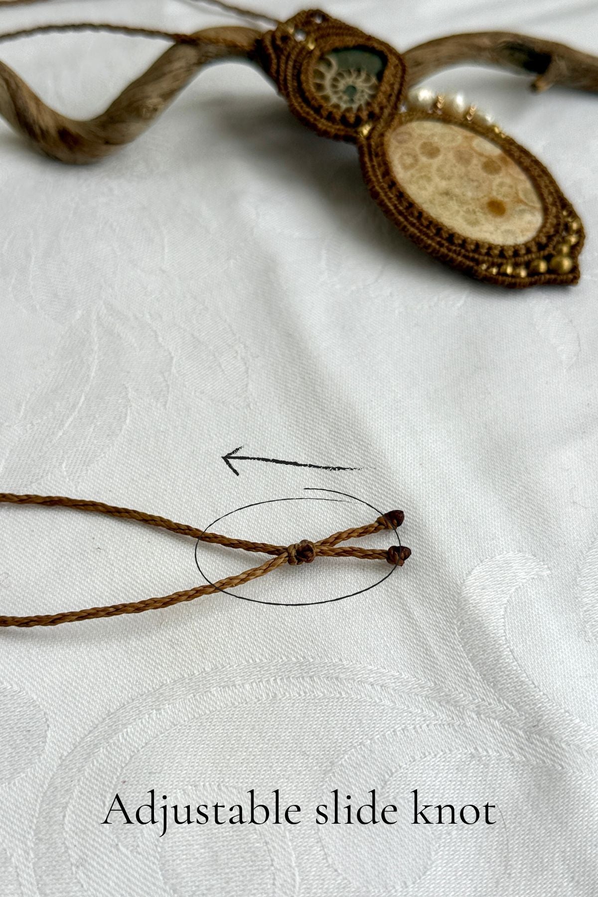 Adjustable slide knot closure on handmade ammonite fossil statement necklace.