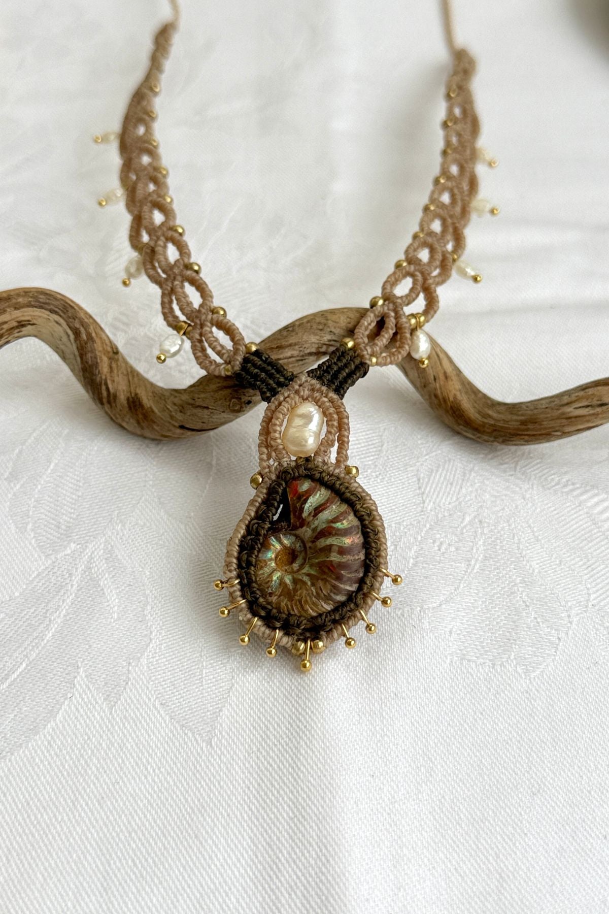 Close-up of iridescent ammonite fossil with luminous freshwater pearl detail