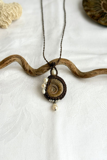 Close-up of spiral ammonite with freshwater pearls, natural history jewelry
