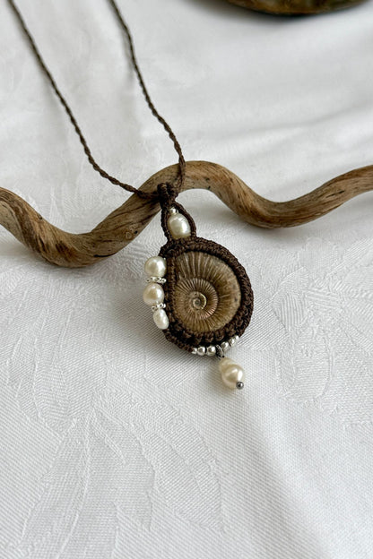 Detailed view of raw ammonite fossil necklace with organic textures and asymmetrical design